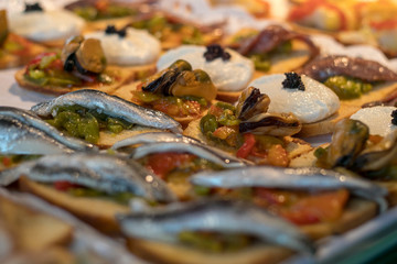 Pintxos, Brushetta, tapas, spanish canapes seafood, mussels, sardines and cod in San Miguel Market Madrid 