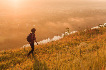 Anonymous traveler walking in meadow