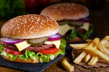 juicy beef burger, french fries, wooden board