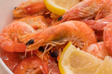 delicious boiled tiger shrimps with lemon slices. close-up