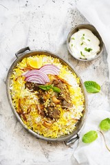 Homemade Beef Biryani served with Raita yogurt dip, overhead view