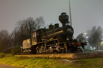 KOUVOLA, FINLAND - NOVEMBER 7, 2018: Old steam locomotive as an exhibit at the Kouvola railway station in Finland at night.
