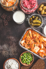 Probiotics food concept. Kimchi, beet sauerkraut, sauerkraut, cottage cheese, peas, olives, bread, chocolate, kefir and pickled cucumbers.