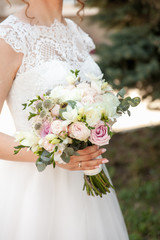 Wedding bouquet in hands of the bride