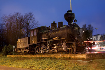 KOUVOLA, FINLAND - NOVEMBER 8, 2018: Old steam locomotive as an exhibit at the Kouvola railway station in Finland at night.
