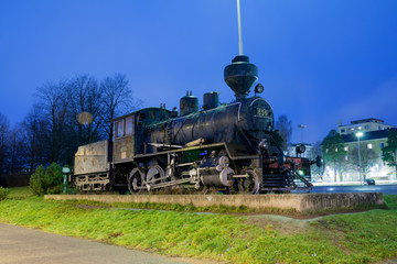 KOUVOLA, FINLAND - NOVEMBER 8, 2018: Old steam locomotive as an exhibit at the Kouvola railway station in Finland at night.