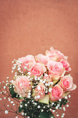 Vertical image of tender pink roses with copy space