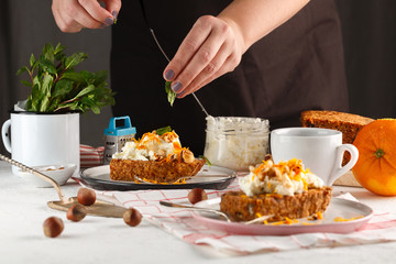 carrot fruit cake. Girl decorates carrot cake.