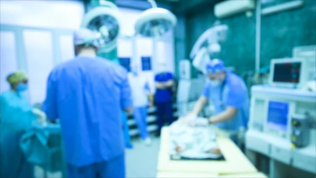 neurosurgeons perform surgery to excise a brain tumor in a modern surgical operating room. blur focus