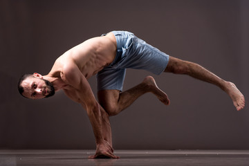 A topless man dancer performing a dancing moves