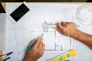 Top view of Confident team of architect working together on blueprint.They discussing about new...