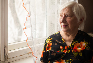 Senior lady looking at window