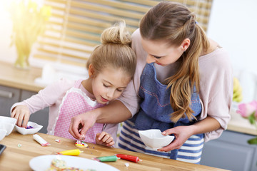 Fototapeta premium Mother and daughter preparing cookies in the kitchen