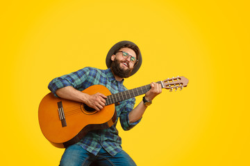 Bearded man playing guitar