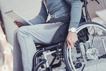 Obraz premium Nice young man moving his wheelchair