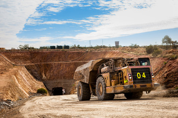 Trucks laden with ore leaving a copper mine tunnel in NSW Australia.