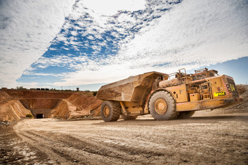 Trucks laden with ore leaving a copper mine tunnel in NSW Australia.