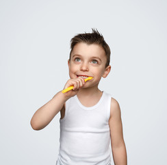 Dreaming boy brushing teeth