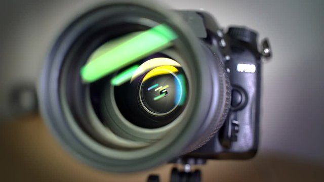 Diaphragm blades opening and closing aperture of a DSLR camera lens.