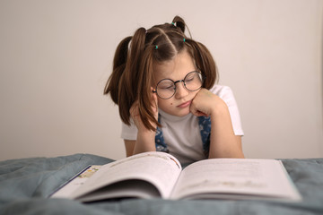 Smart funny girl in glasses with tails reads book