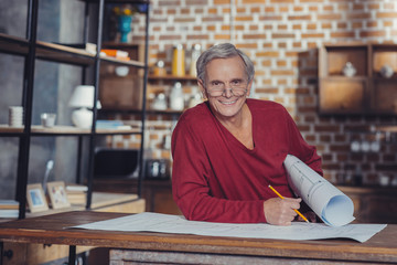 Positive retired engineer feeling glad and smiling