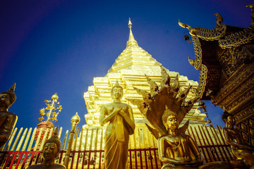 Buddhist temple in Thailand wat pra that Doi Suthep with golden statues adorning