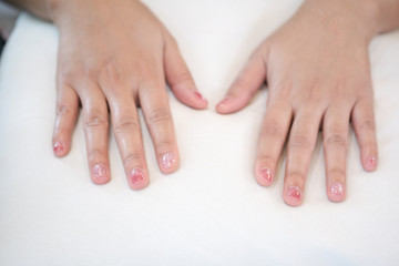 Hands placed on a white pillow