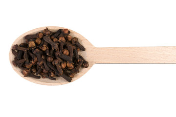 cloves on wooden spoon isolated on white background