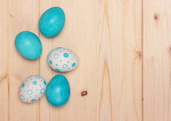 Easter eggs on light-coloured wooden background