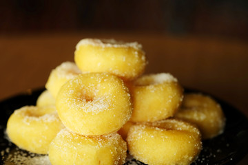 Fried donut with sugar, popular sweet  sold in market or restaurant, high calories, sugar and cholesterol level cause of many chronic disease such as diabetes and heart disease affect economic problem