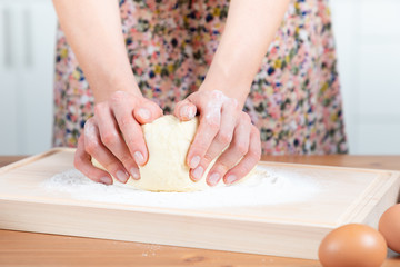 Obraz na płótnie Canvas Young beautiful girl making dough