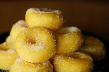 Fried donut with sugar, popular sweet  sold in market or restaurant, high calories, sugar and cholesterol level cause of many chronic disease such as diabetes and heart disease affect economic problem