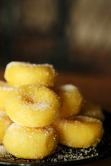 Fried donut with sugar, popular sweet  sold in market or restaurant, high calories, sugar and cholesterol level cause of many chronic disease such as diabetes and heart disease affect economic problem