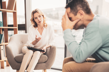 Helpful therapist asking needed questions during work