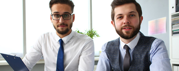 Group of businessmen with financial graph and silver pen in arm solve and discuss problem with colleague portrait. Situation examination at board council sale adviser job stock exchange market profit