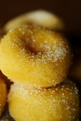 Fried donut with sugar, popular sweet  sold in market or restaurant, high calories, sugar and cholesterol level cause of many chronic disease such as diabetes and heart disease affect economic problem