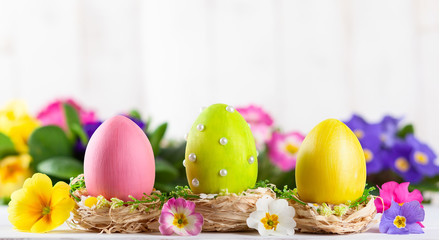 Easter composition with colorful Easter eggs  and spring flowers.
