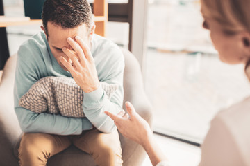 Fototapeta premium Stressed man feeling overloaded after busy workday