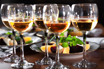 Set of wineglasses and plates with salad in the beautifull light