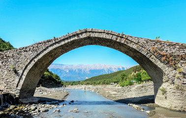 Fototapeta na wymiar Beautiful Katiu Bridge in front of albanian Mountains, Benja, Albania, Europe