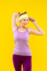 Woman wearing yellow head band stretching muscles