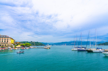 Gulf of Spezia turquoise water with yachts and boats from Portovenere coastal town and blue cloudy dramatic sky copy space background, Ligurian sea, Riviera di Levante, La Spezia, Liguria, Italy