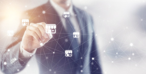 Businessman hand writing icon franchise marketing system in global network connection.