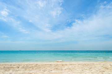 Fototapeta na wymiar Sunny day on a white sand and aquamarine beach