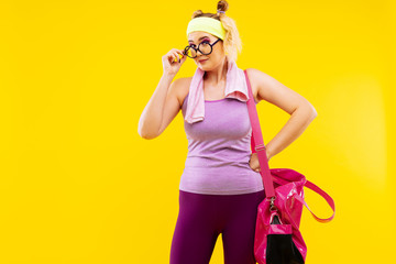 Young woman wearing glasses feeling excited before gym