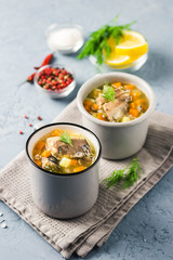 Canned fish soup with fresh herbs and lemon. Selective focus, space for text.
