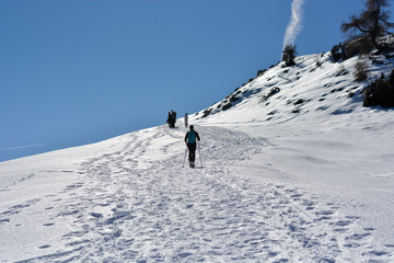 the skier goes towards the top of the mountains