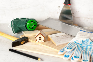 Model of the house on a wooden background. The concept of construction and renovation. Selective focus.