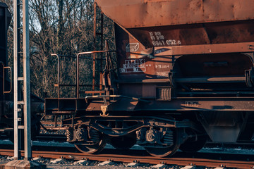 Fototapeta na wymiar a rusty old cargo train with a red vintage look on a sidetrack