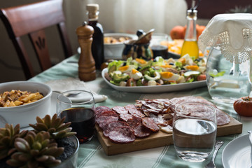 Macaroni with salad, sausages, bread and orange with cinnamon.